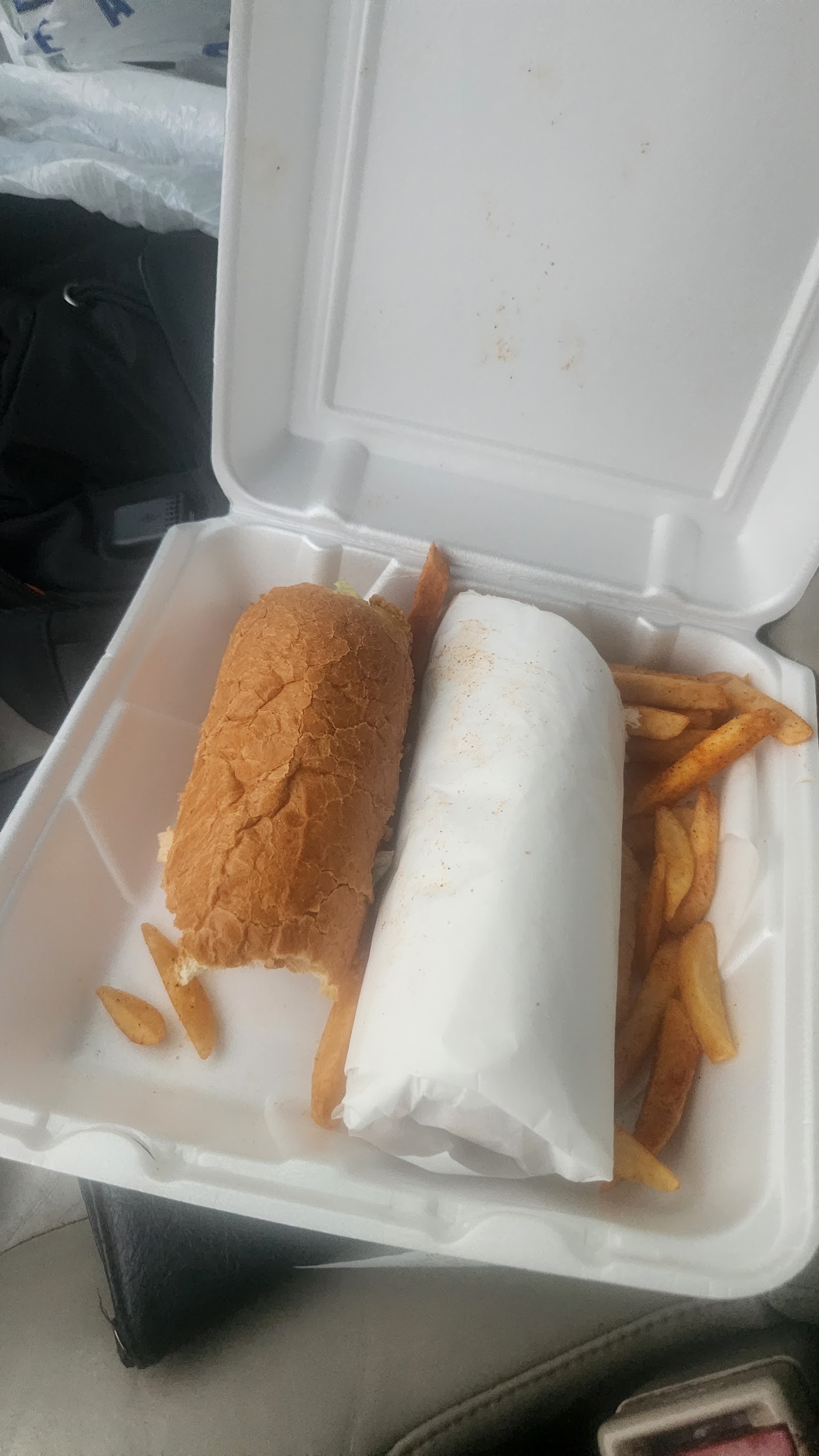 Fried po-boy sandwich with seasoned fries at Sauce's Southern Kitchen